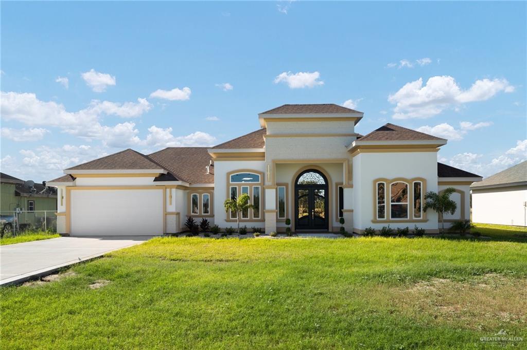 a front view of house with yard and green space