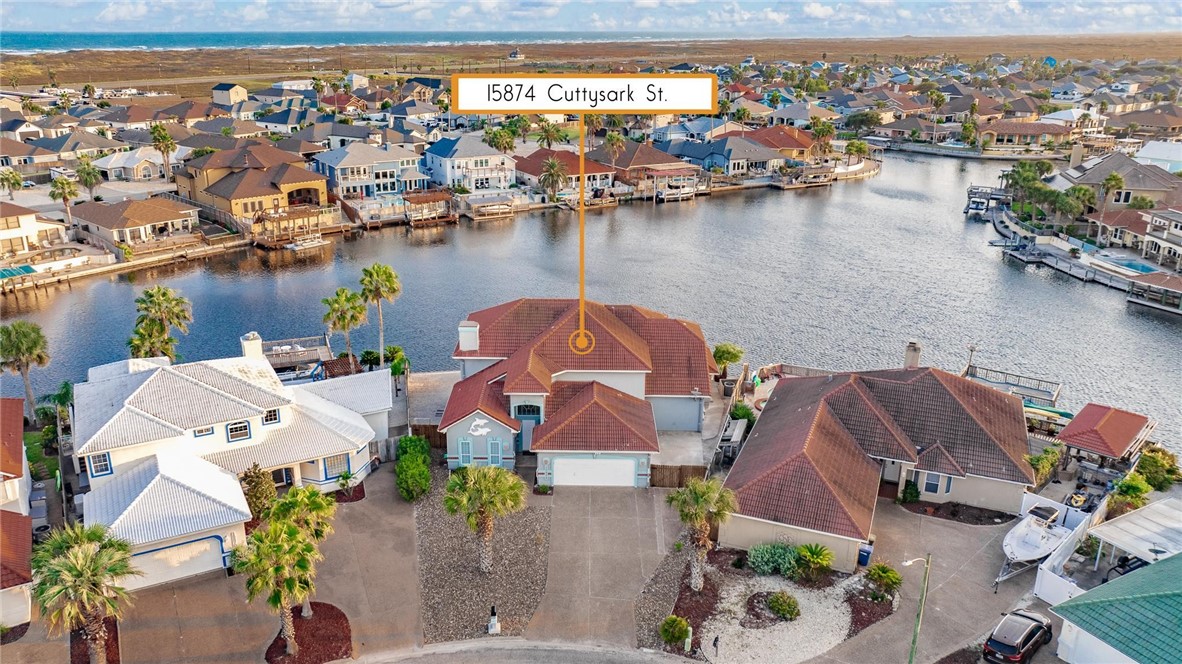 an aerial view of house with yard and ocean view