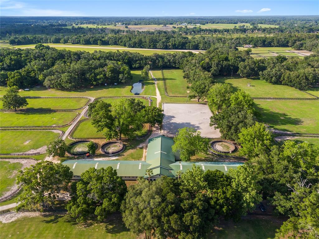 an aerial view of a house with a garden and lake view