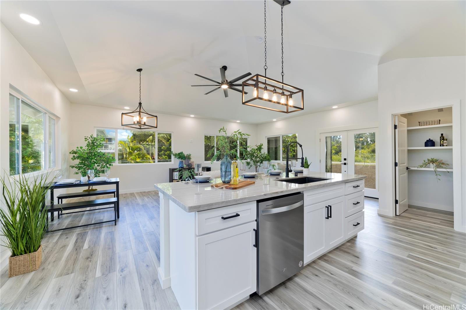 a kitchen with stainless steel appliances kitchen island a large island in the center and wooden floor