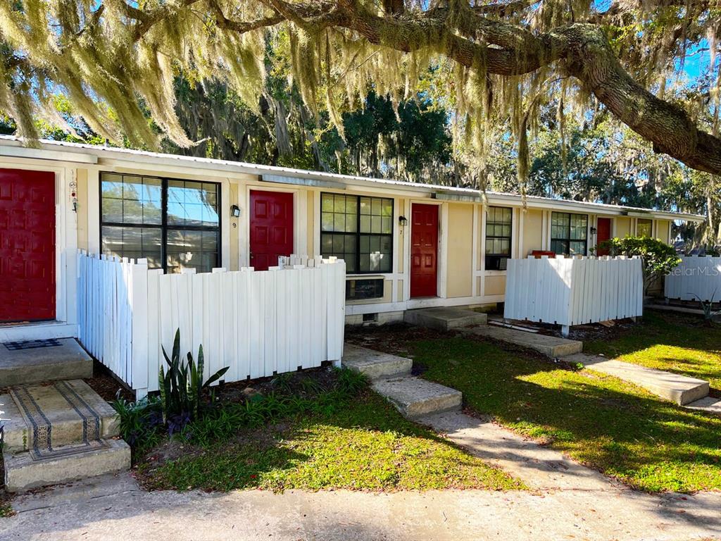 a view of a house with backyard and sitting area