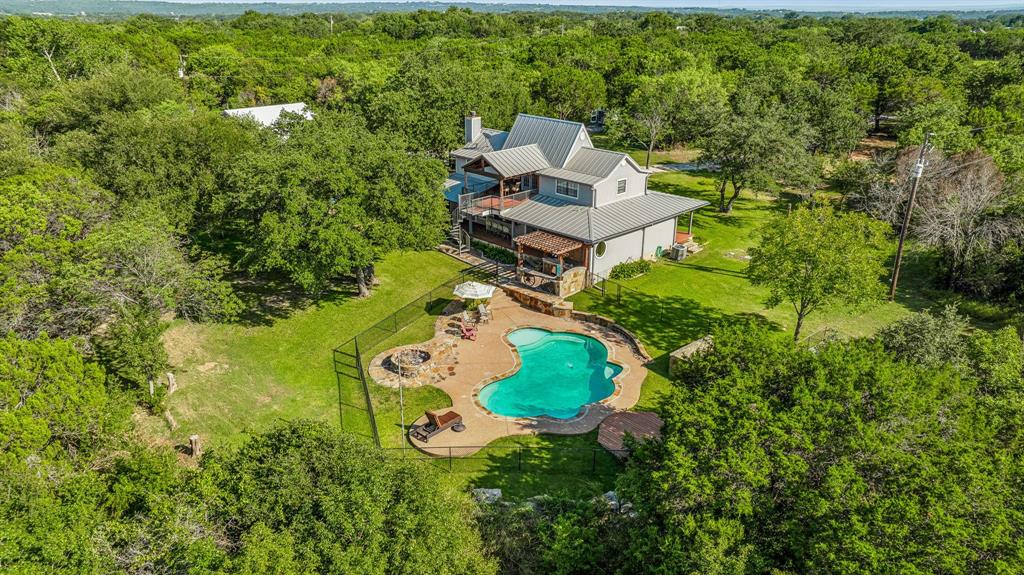 an aerial view of a house with garden space and street view