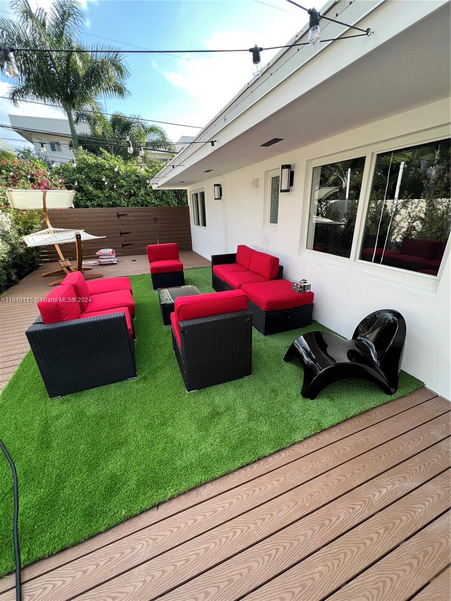 a view of a backyard with sitting area