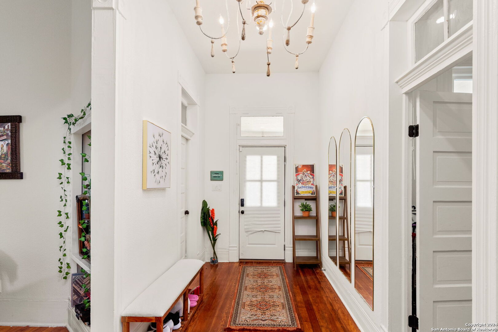 a view of a hallway with closet and wooden floor