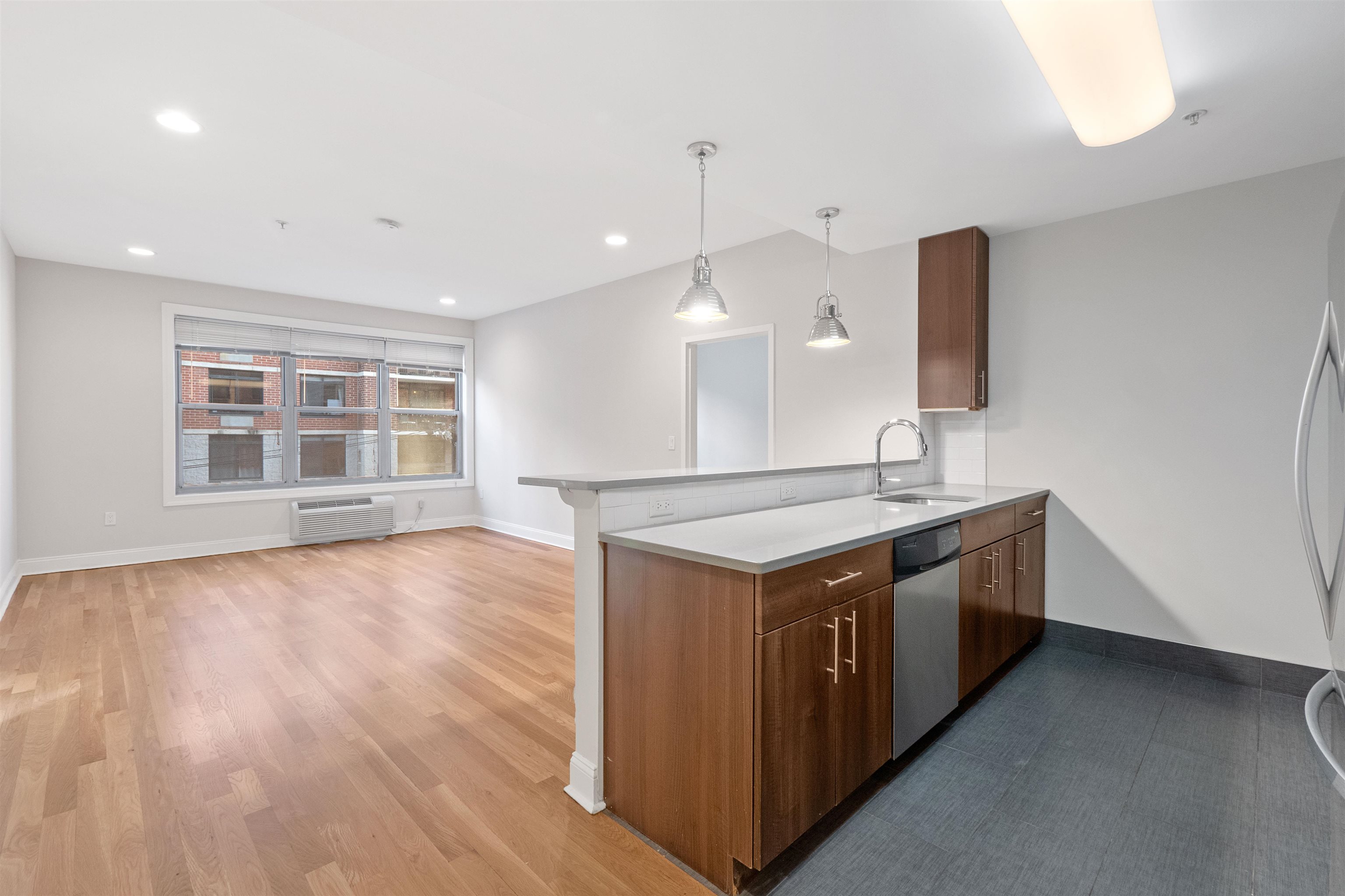 a kitchen with a stove and wooden floor