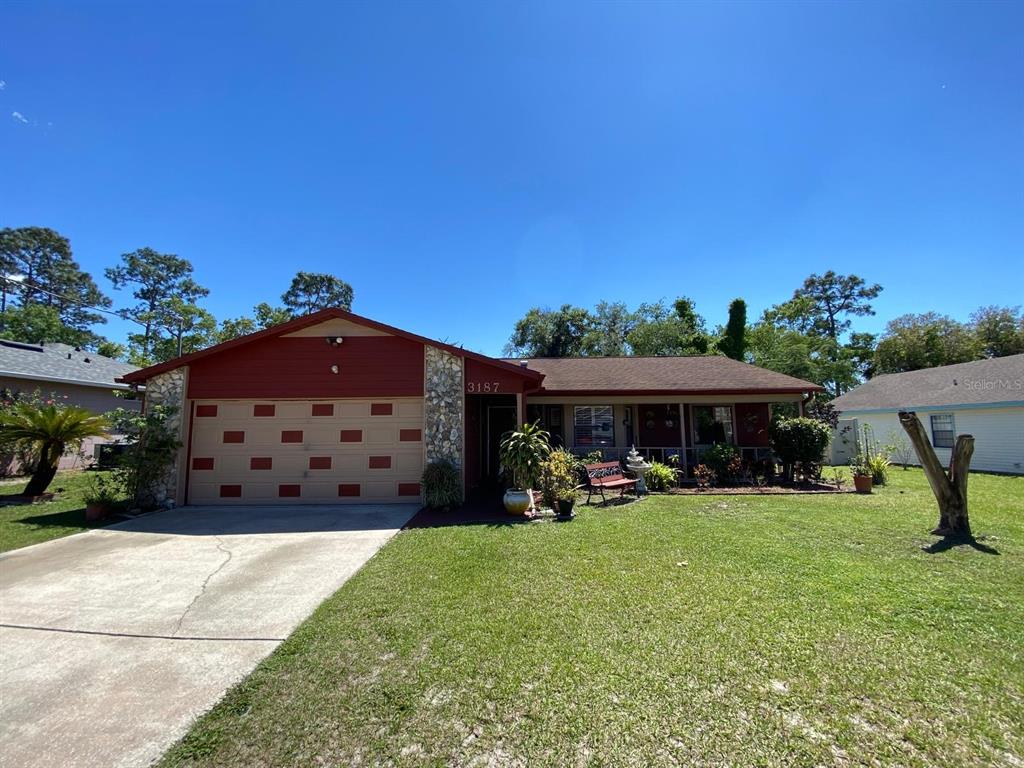 a view of a house with a yard and sitting area