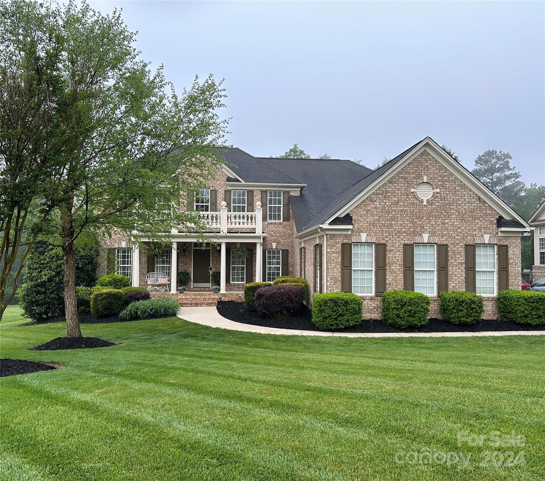 a front view of a house with a garden and porch