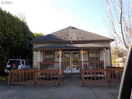 a view of a house with a chairs and table in a patio