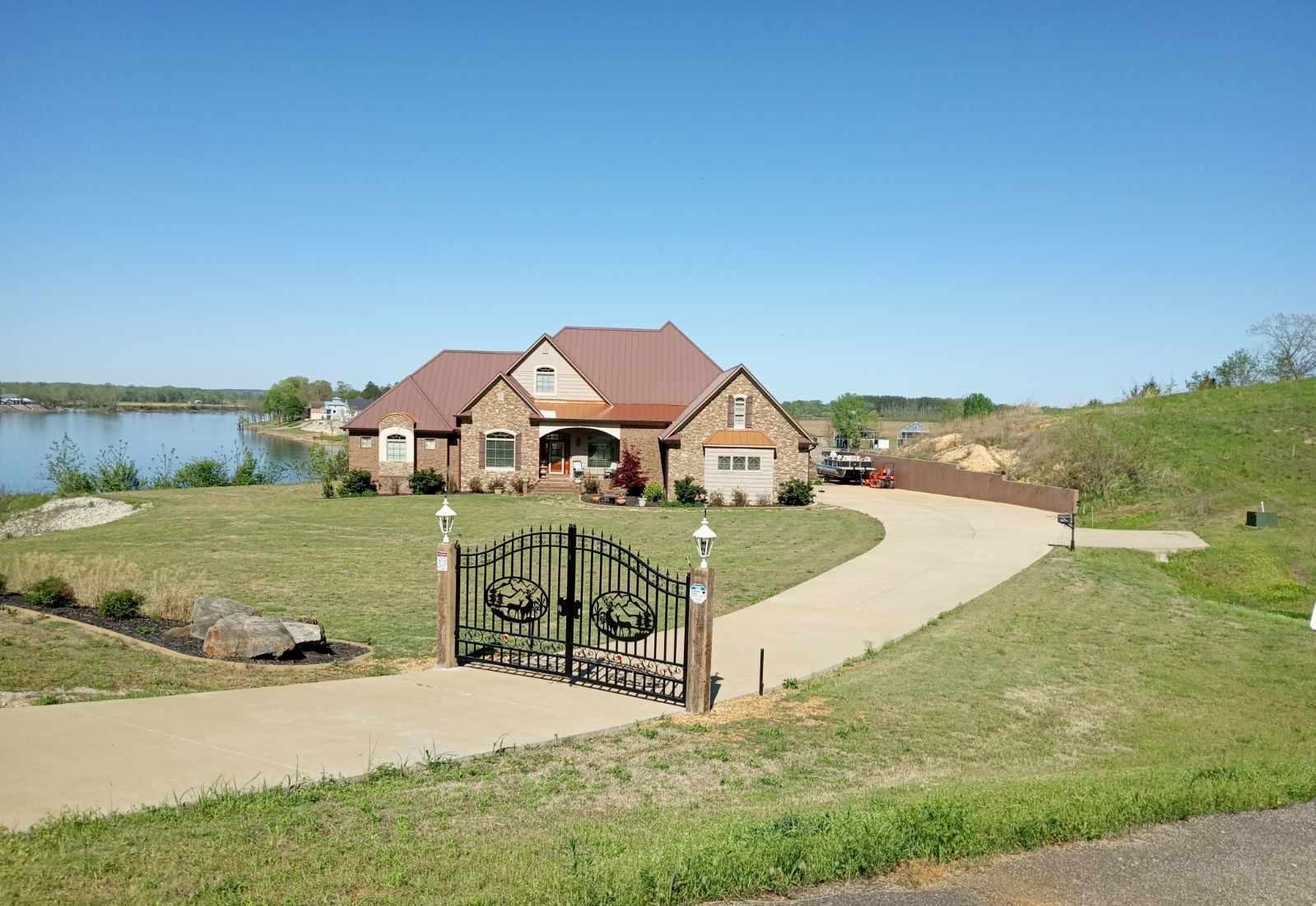 View of property's community featuring a yard and a water view