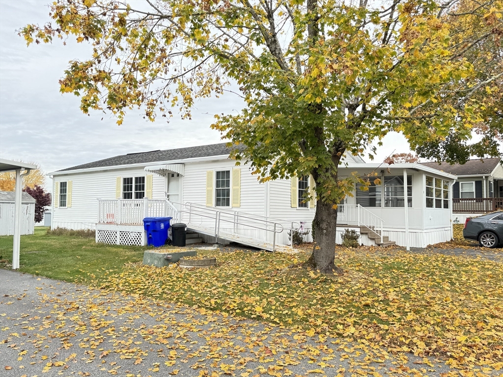 a view of a house with a backyard