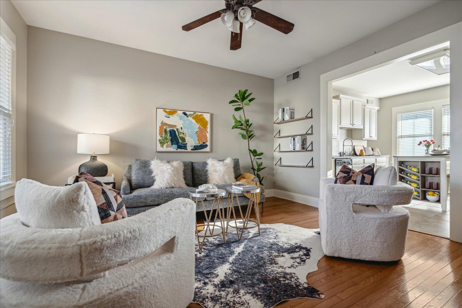 Living room featuring ceiling fan, sink, and hardwood / wood-style flooring