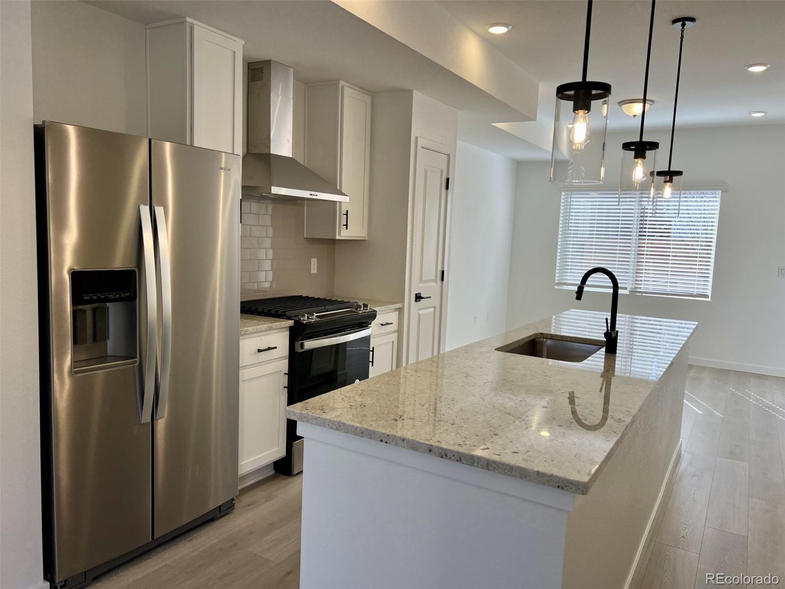 a kitchen with refrigerator and countertop