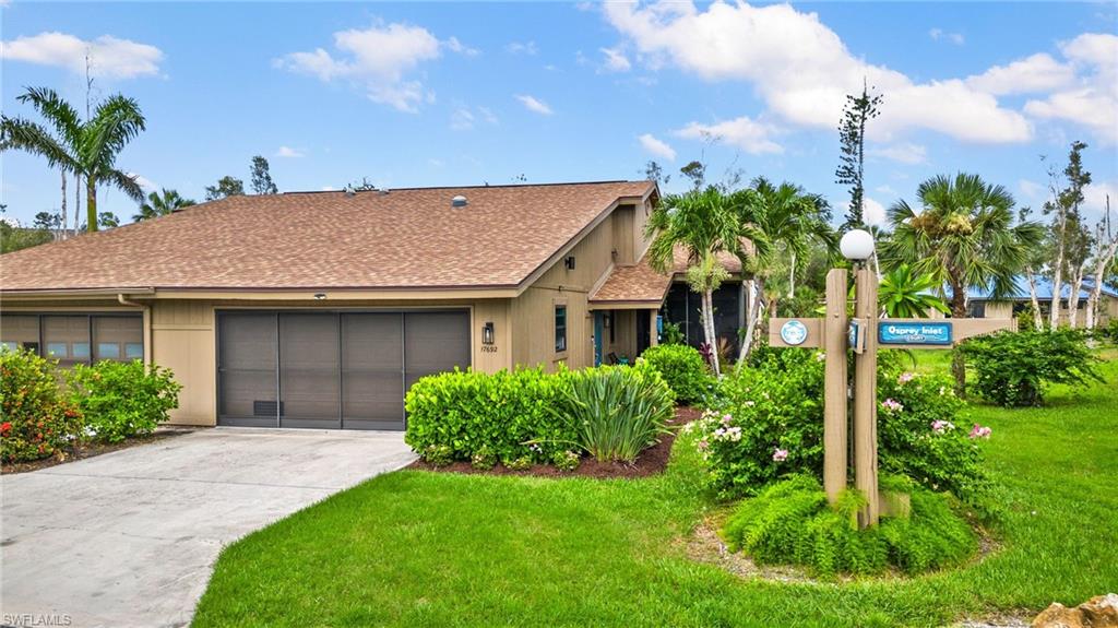 View of front of house featuring a garage and a front yard