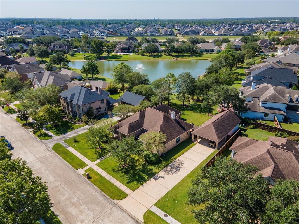 an aerial view of a house with a garden and lake view