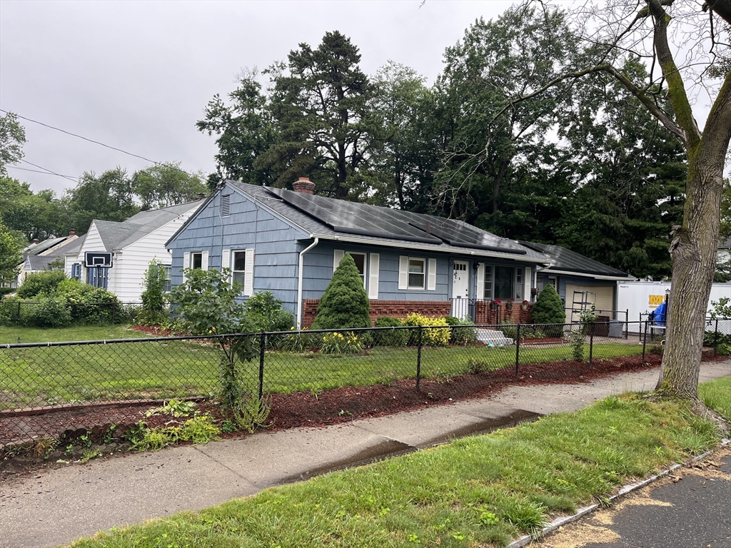 a front view of a house with garden and porch