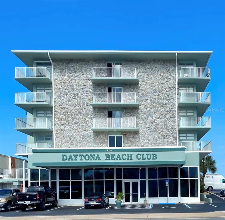 a front view of a building with parking space