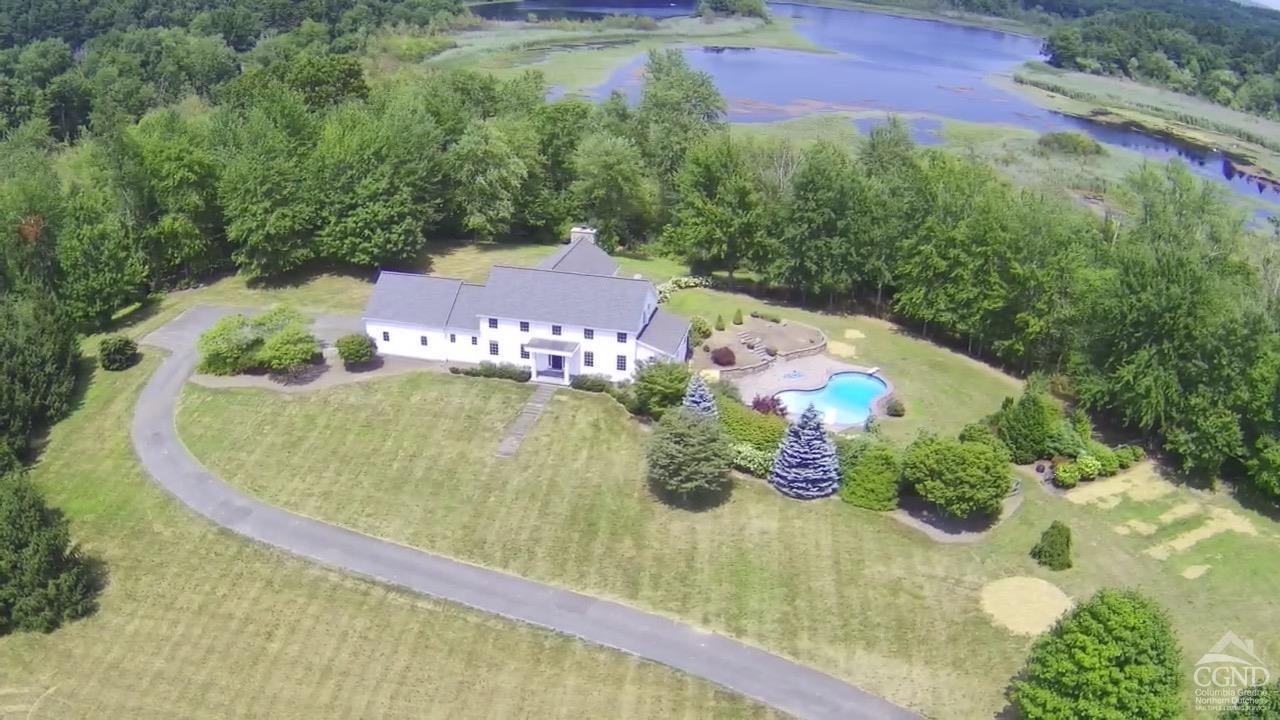 a view of a swimming pool with a yard