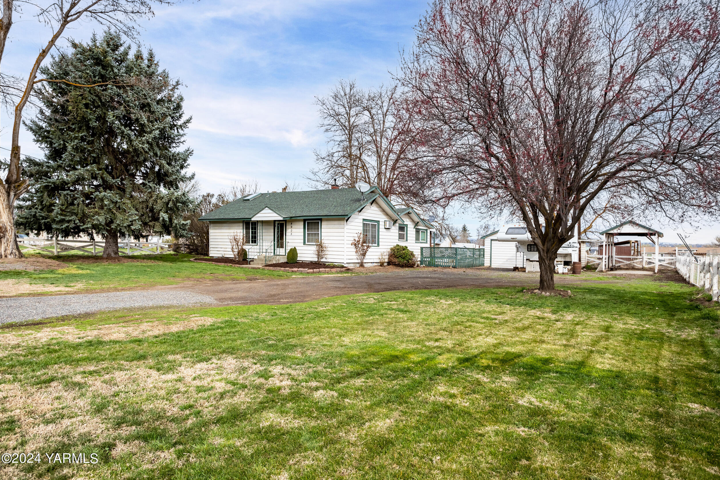 a front view of house with yard and green space