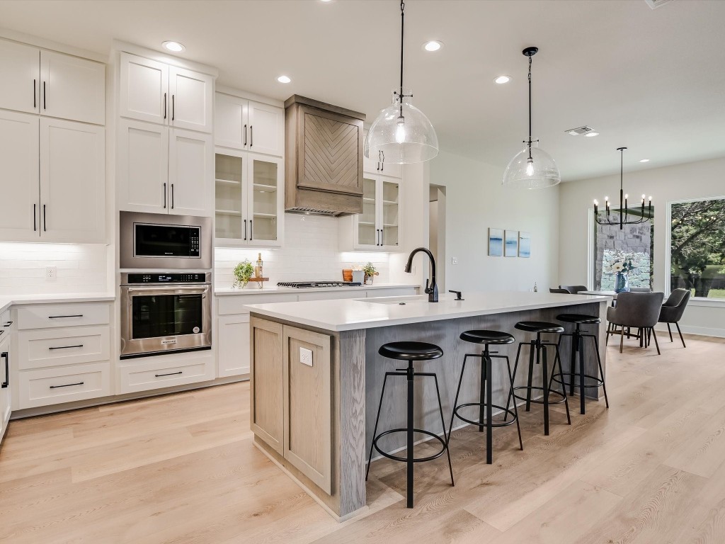 a large kitchen with a table and chairs in it