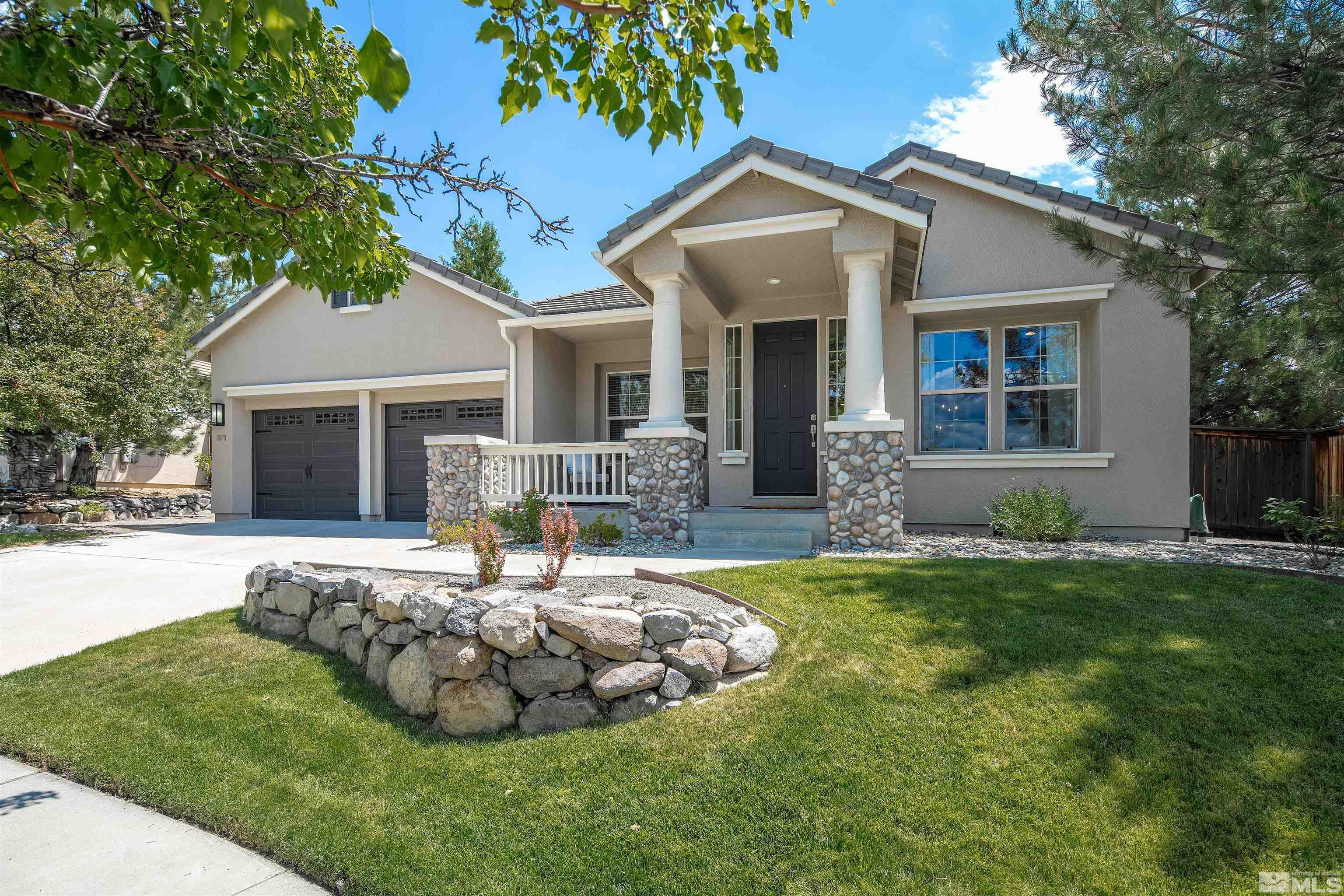 a front view of house with a garden and patio