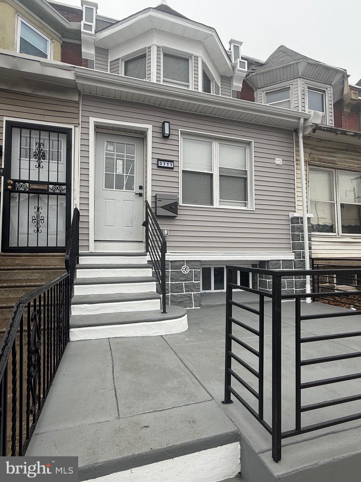 a front view of a house with wooden stairs