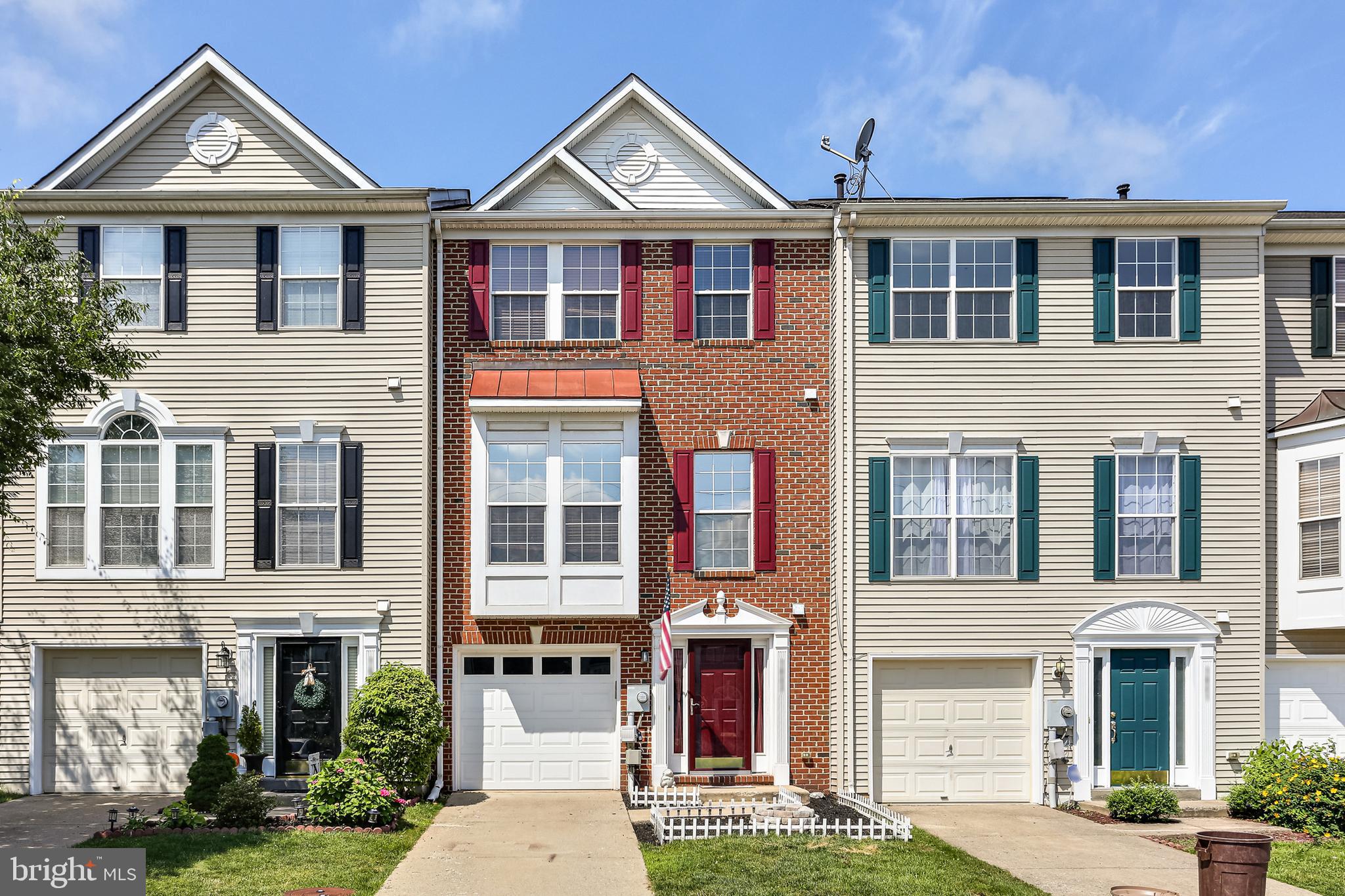 a front view of a residential apartment building with a yard