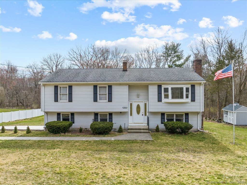 a front view of a house with a yard outdoor seating and barbeque oven