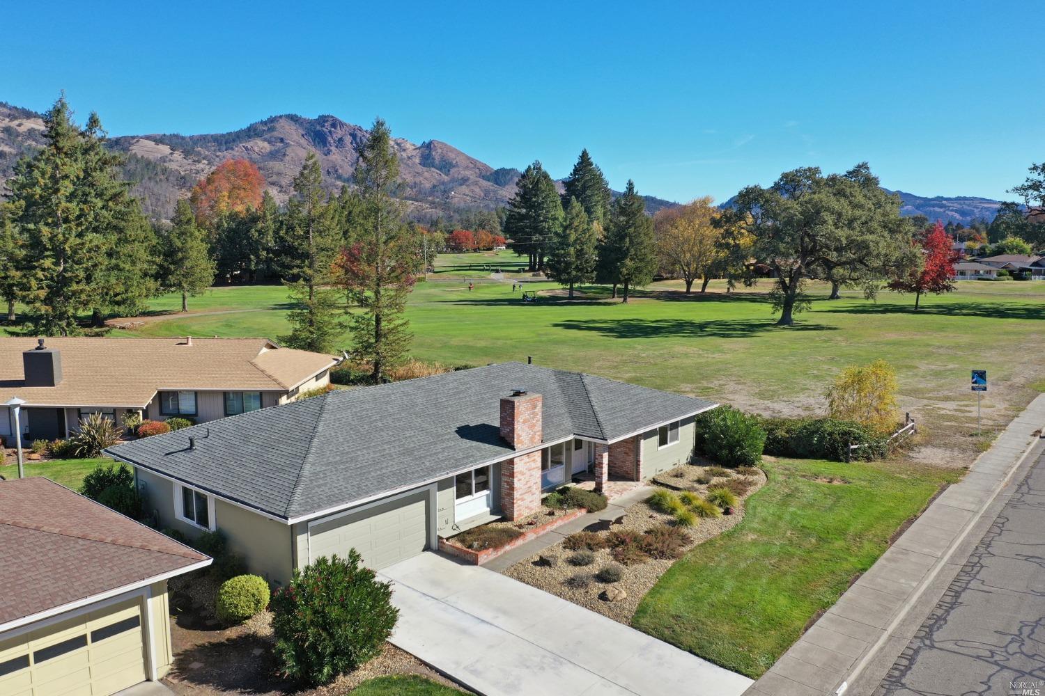 an aerial view of a house with big yard