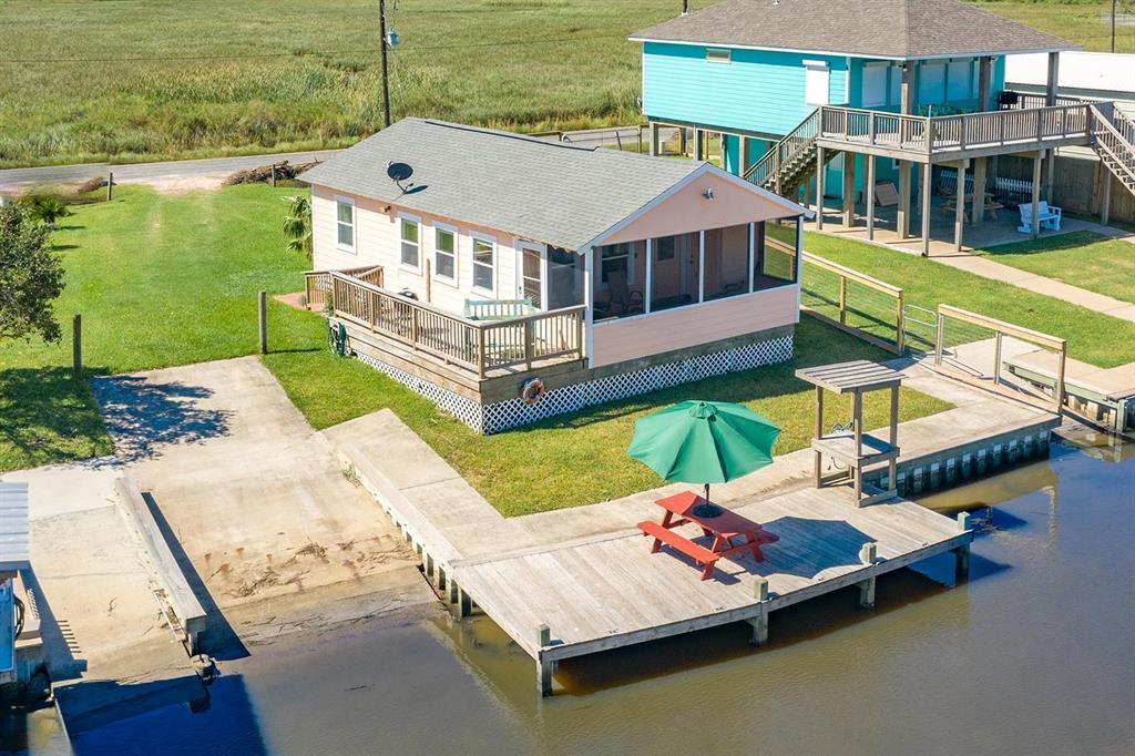 a aerial view of a house with swimming pool having outdoor seating