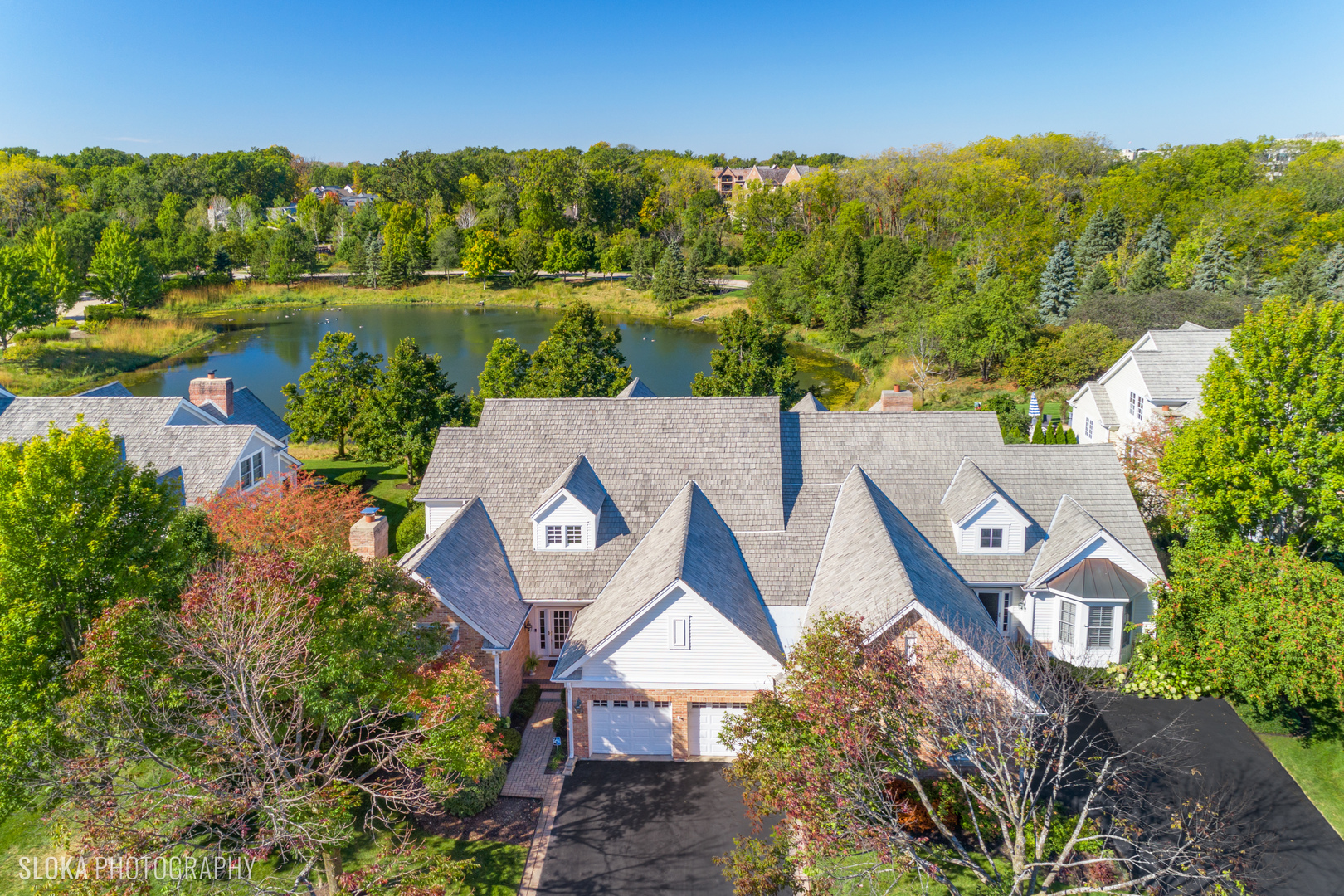 an aerial view of a house with a lake view