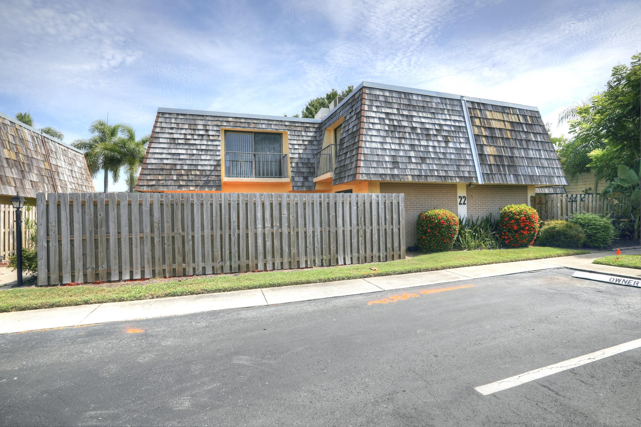 a front view of a house with a fence