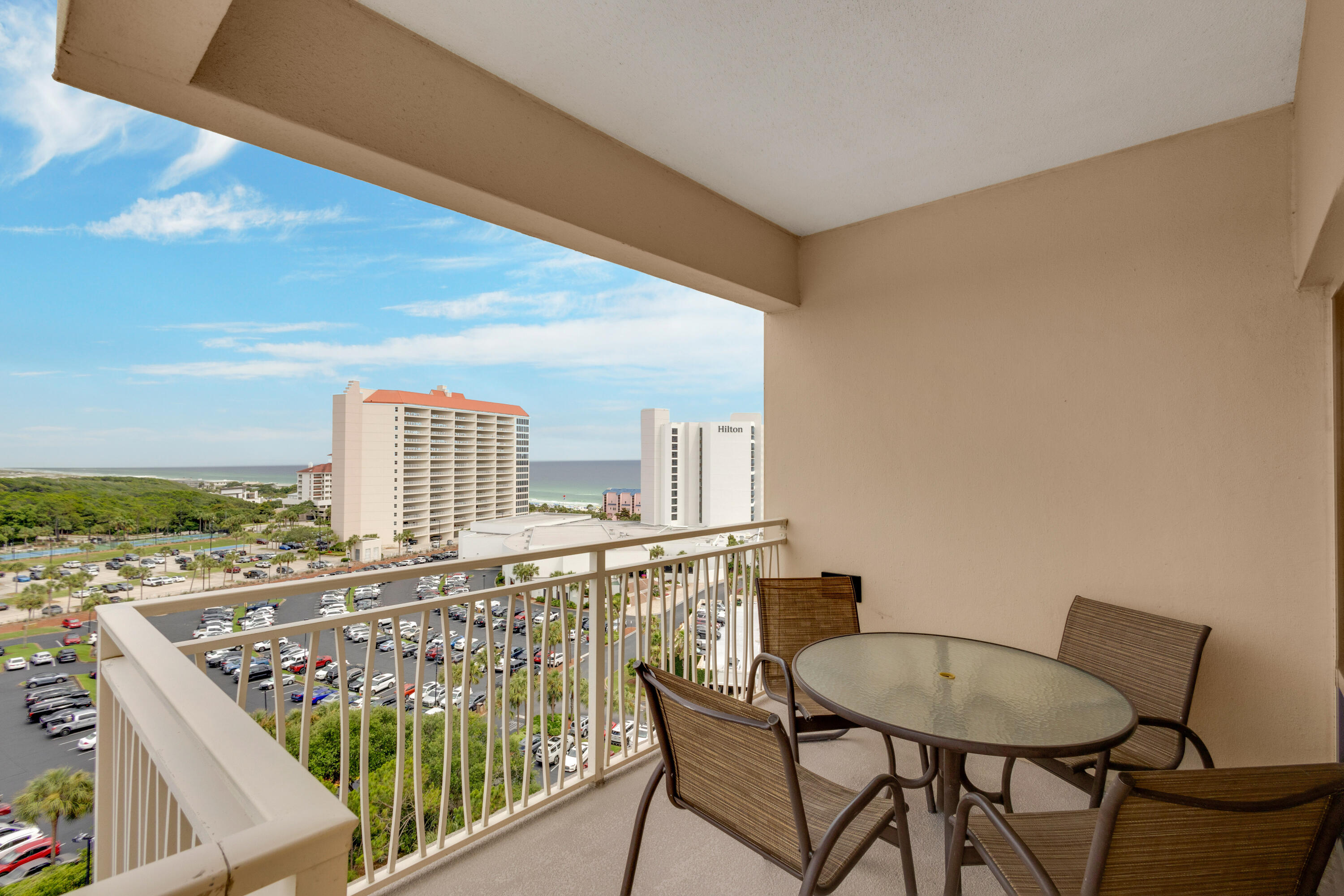 a balcony with table and chairs