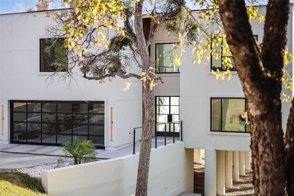 a front view of a house with a tree