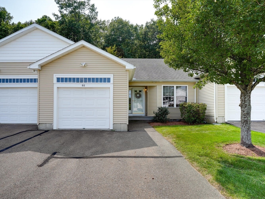 a view of a house with a yard and garage