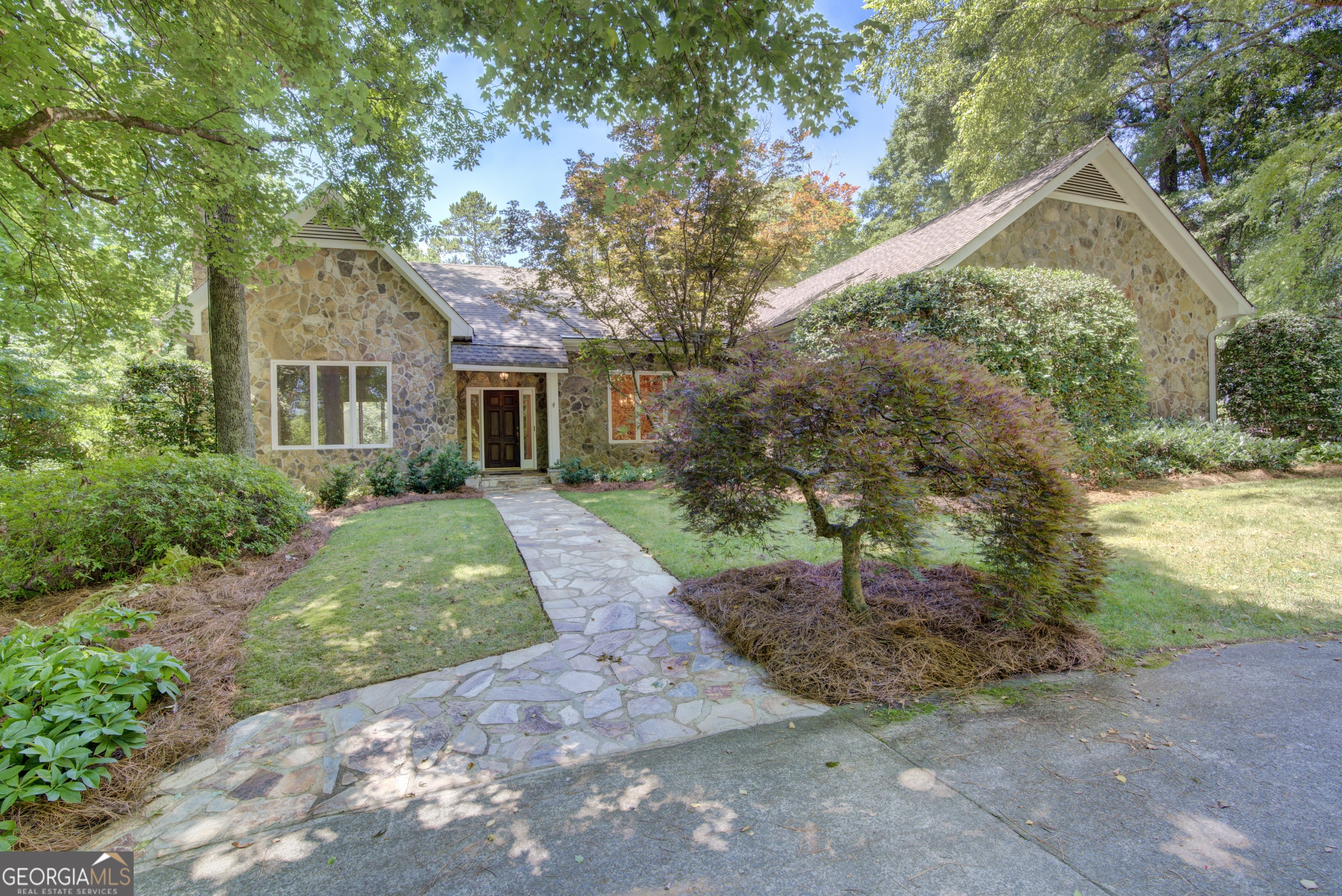 a front view of a house with a yard and an outdoor space