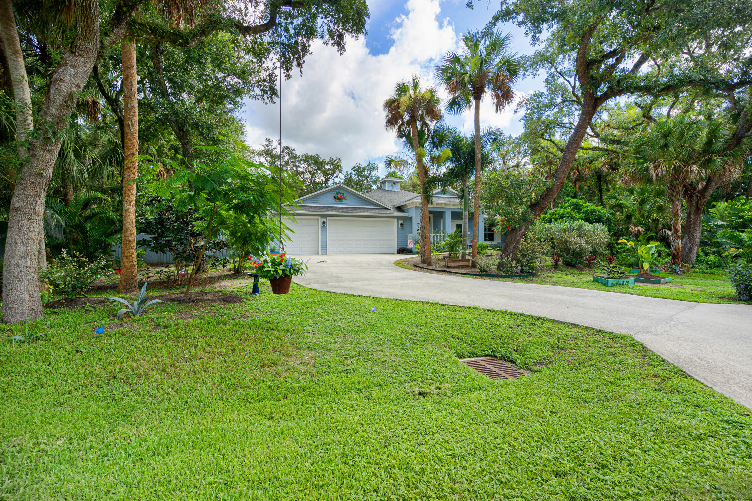 a front view of a house with a yard and tree