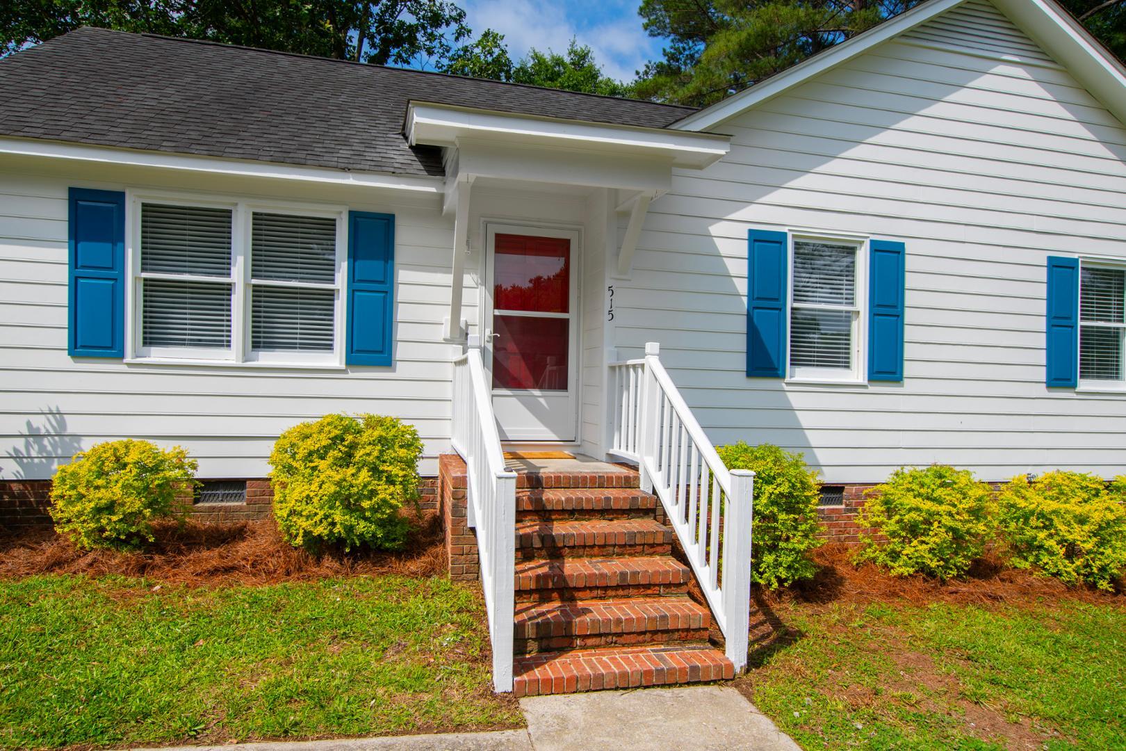 a view of a house with wooden fence