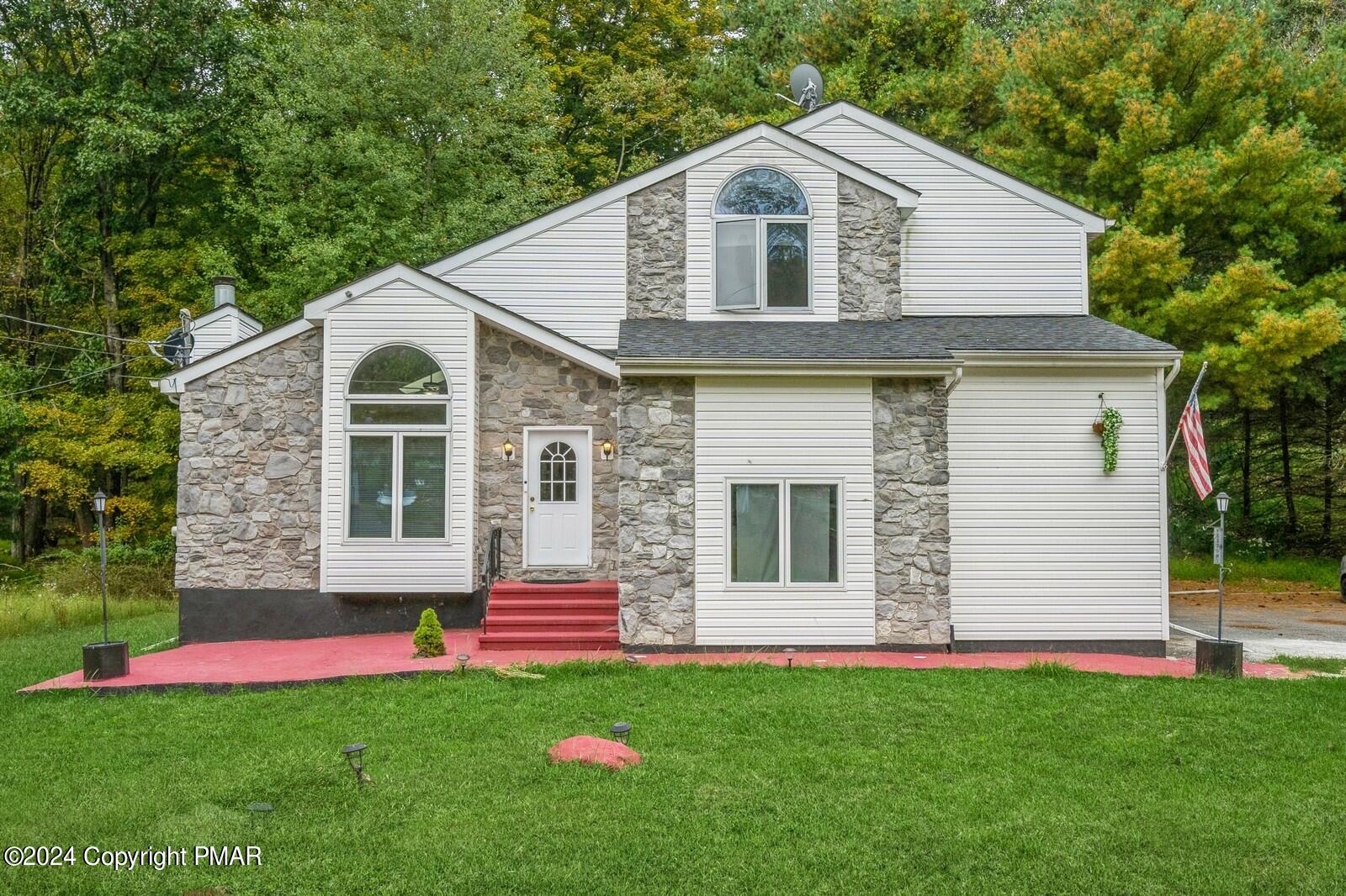 a front view of a house with a yard and garage