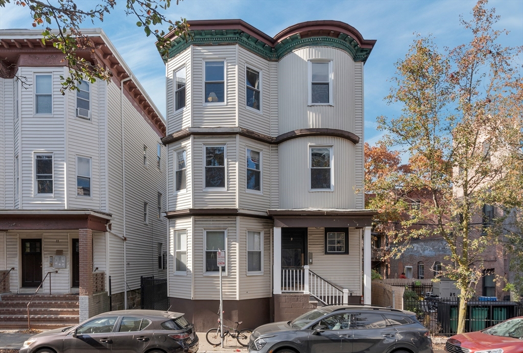 a front view of a residential apartment building with a yard