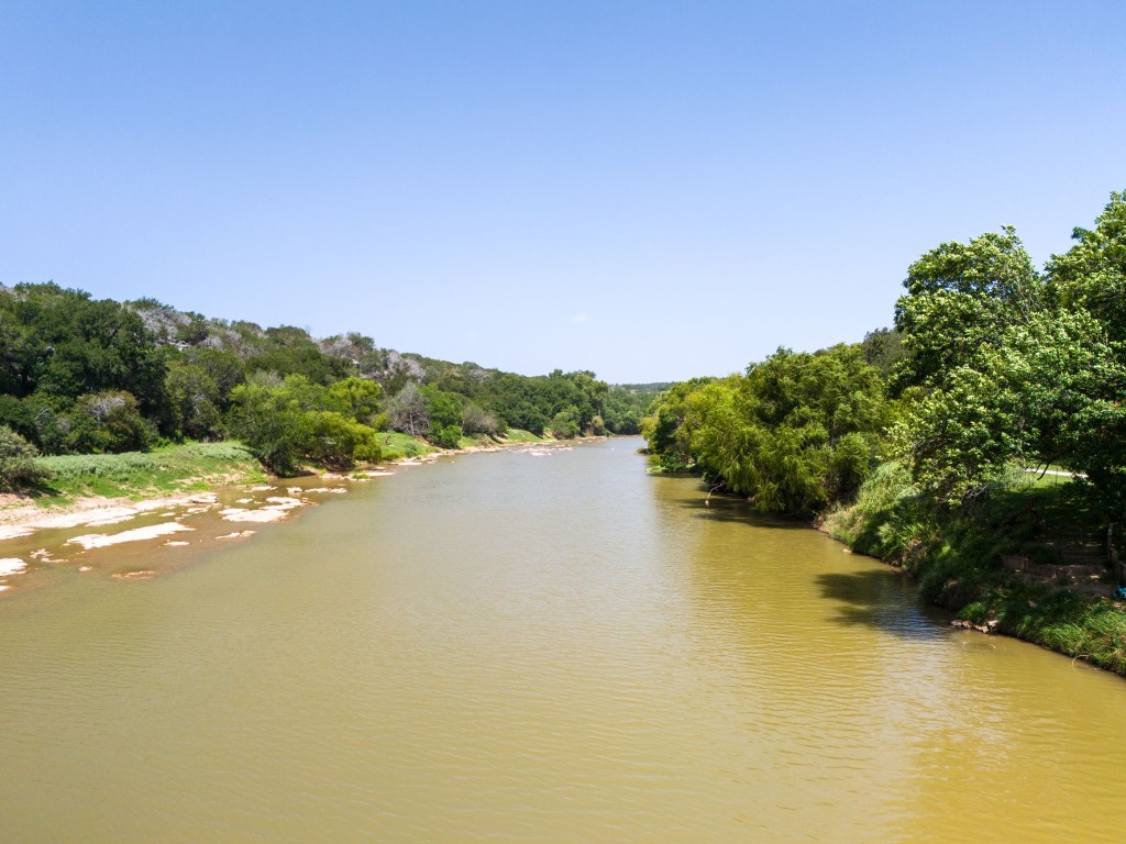 a view of a lake in middle of forest