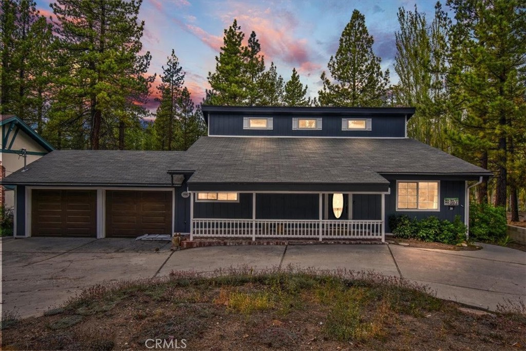 front view of a house with a tree