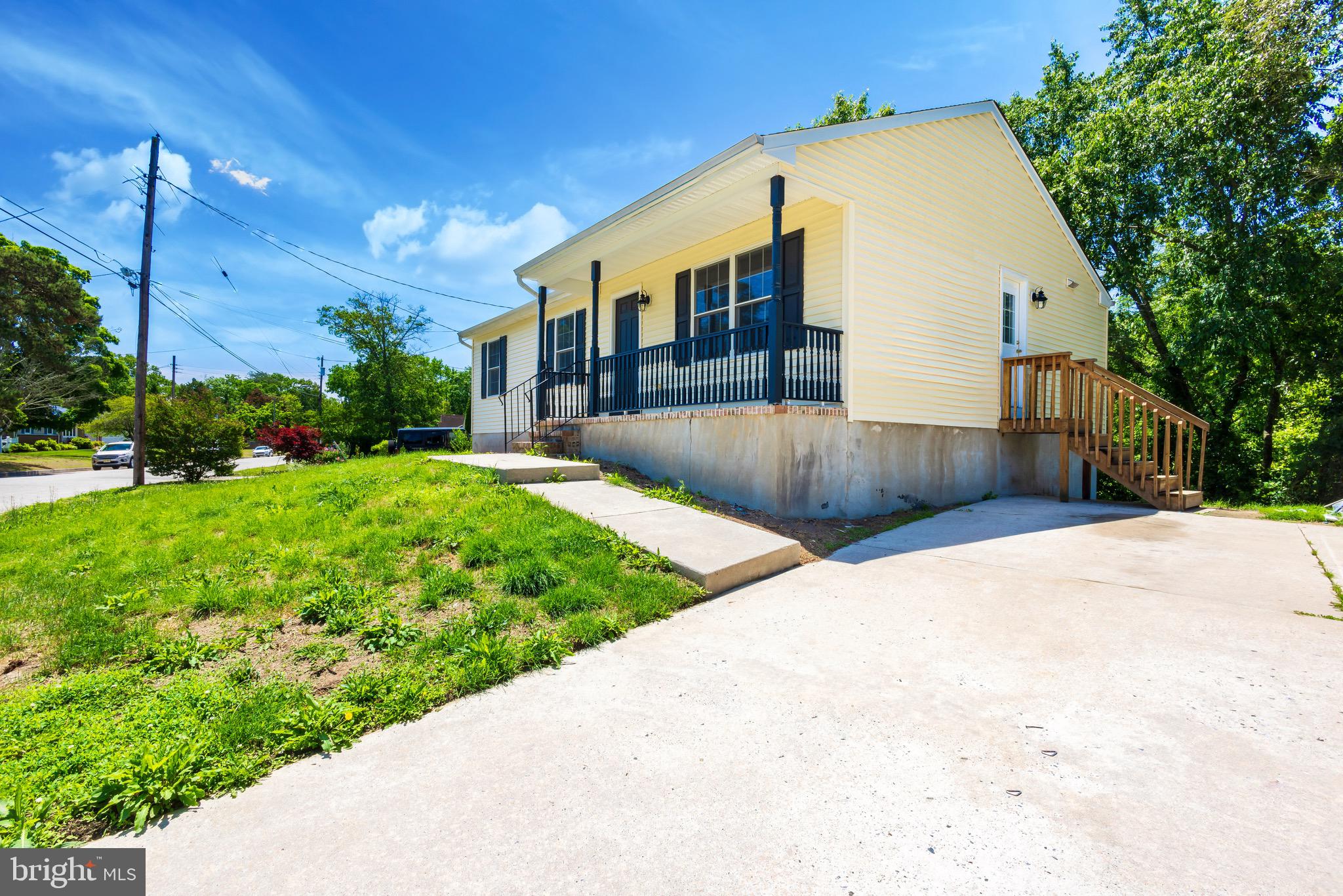 a view of a house with a yard and pathway