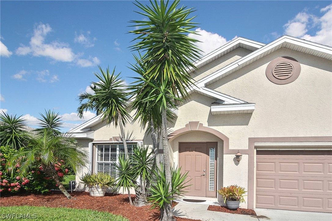 a view of entryway with palm trees