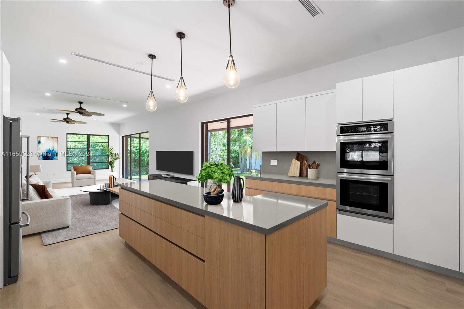 a kitchen with kitchen island white cabinets and stainless steel appliances