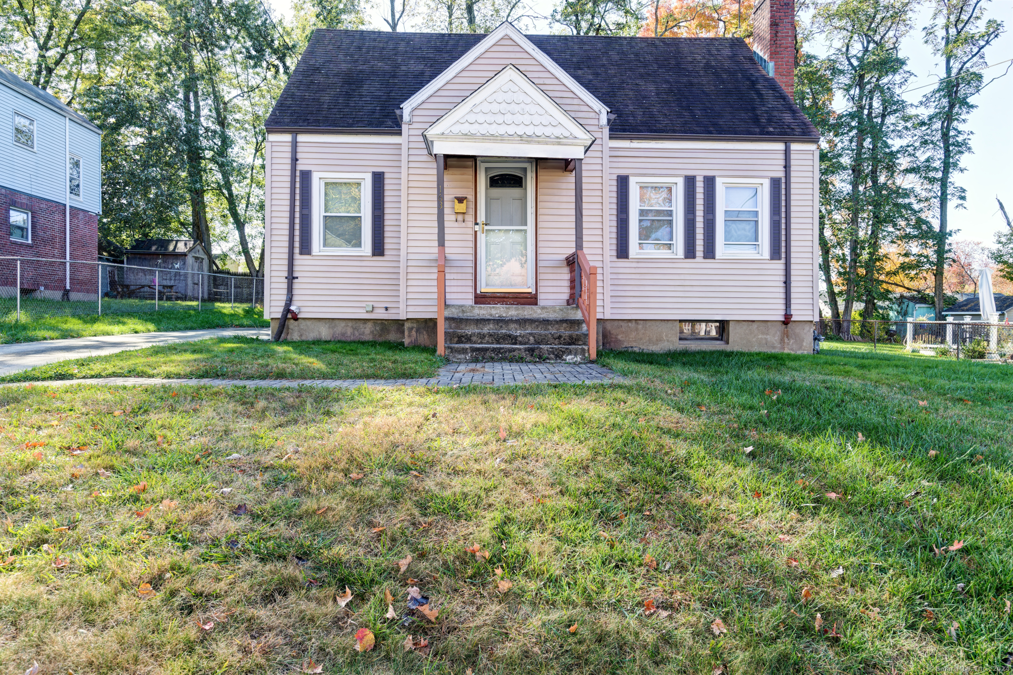 a front view of a house with a garden and yard