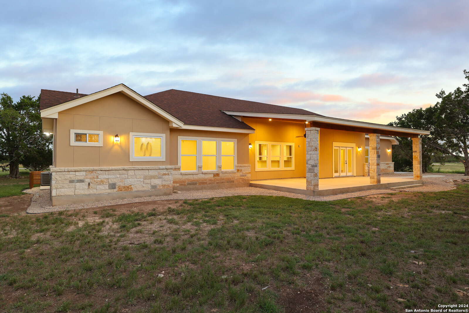 a front view of a house with a garden