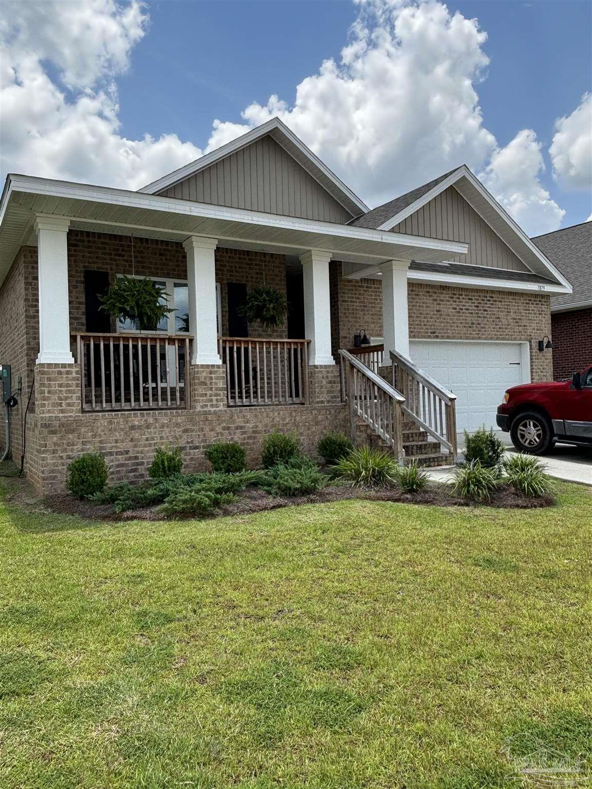 a front view of a house with garden