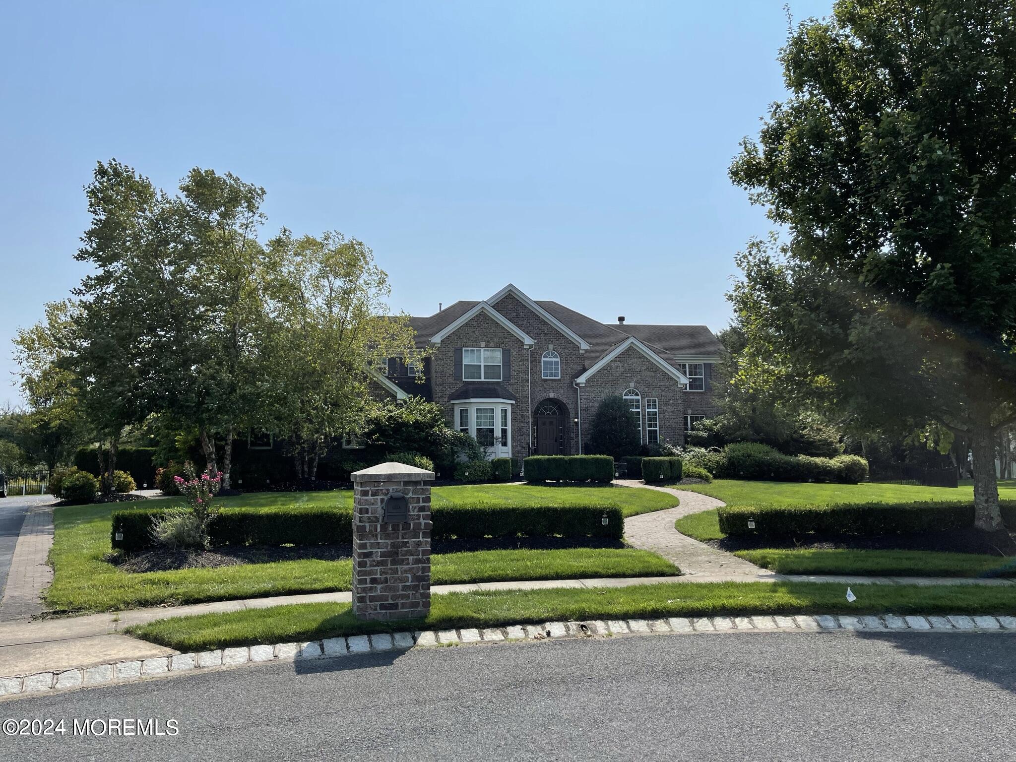 a front view of house with yard and green space