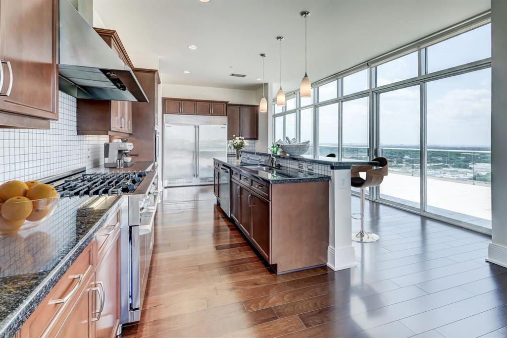 a kitchen with stainless steel appliances granite countertop a stove and a refrigerator