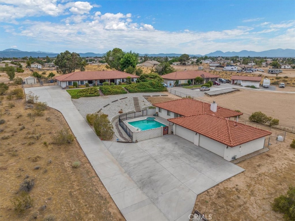 an aerial view of a house with a big yard and lake view